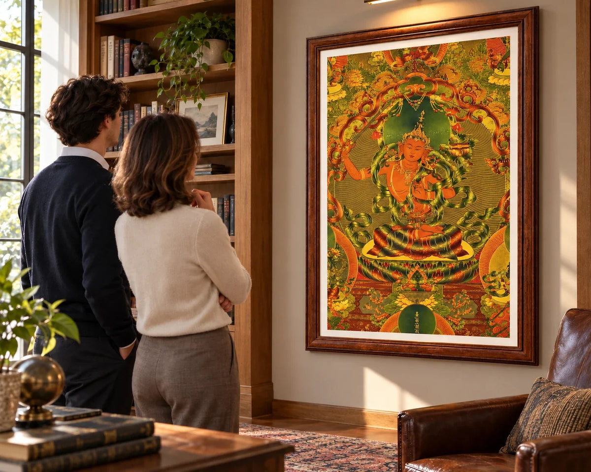 Two people viewing a framed Manjushri Thangka in a living room.