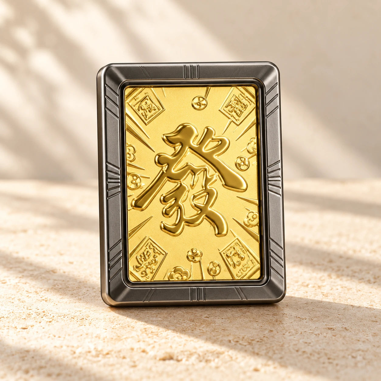 Gold-toned 發 car diffuser with its complete silver-grey rectangular frame on warm stone