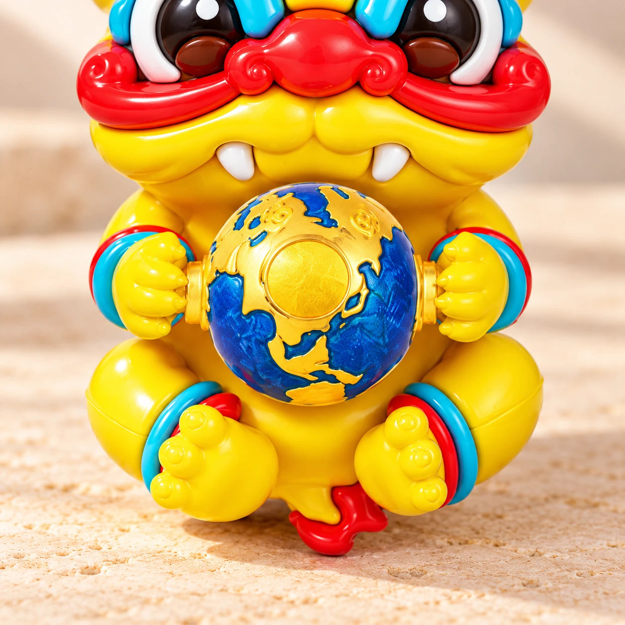 Detail of the blue-and-gold globe held by the Dragon Charm, with its original yellow hands and feet
