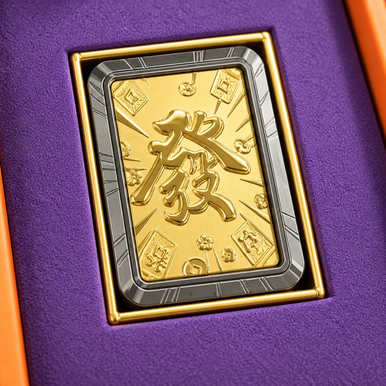 Close detail of the diffuser's embossed gold face, silver-grey border and purple presentation insert