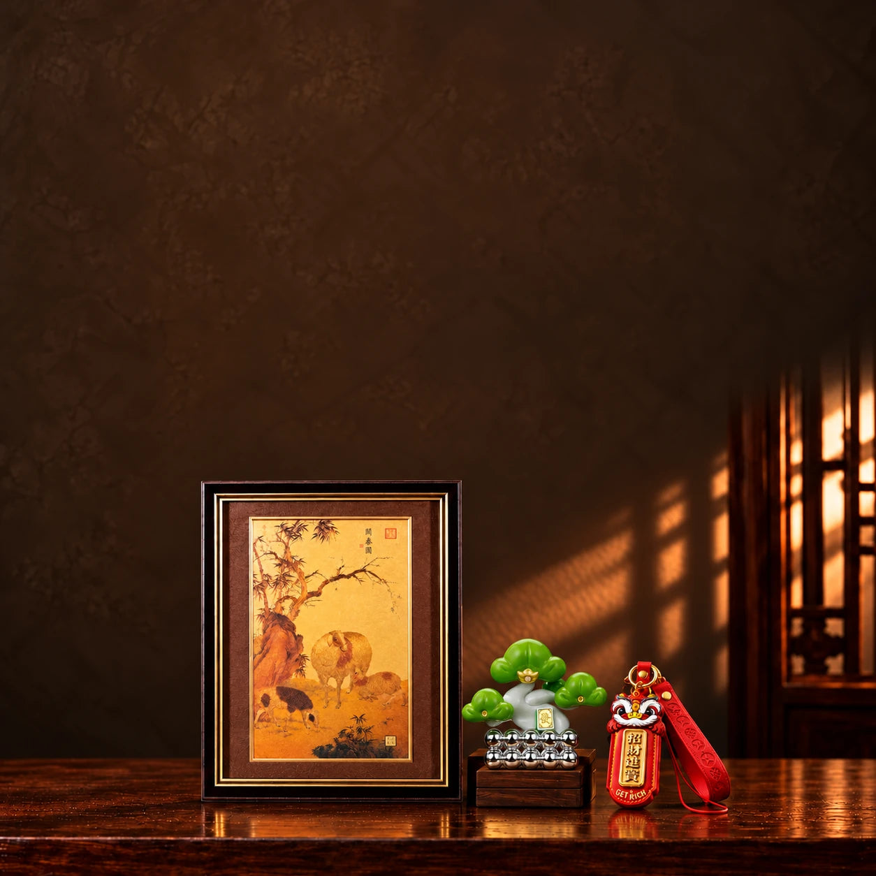Master Xi Three Rams framed artwork, Evergreen Pine ornament and Fortune Lion charm on a dark walnut display.